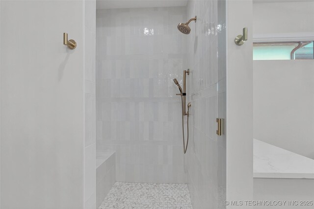 bathroom with a shower with door