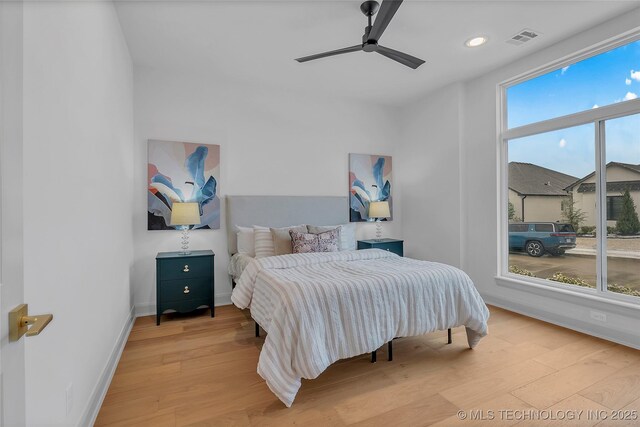 bedroom with ceiling fan and light wood-type flooring