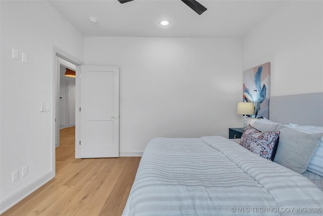 bedroom featuring light wood-type flooring and ceiling fan