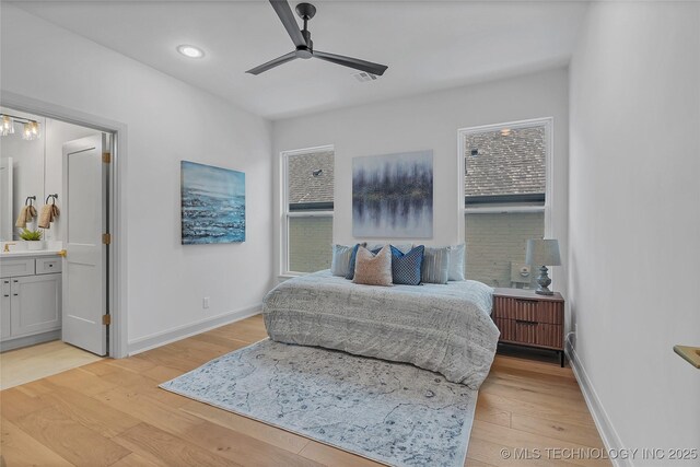 bedroom with connected bathroom, ceiling fan, and light hardwood / wood-style floors