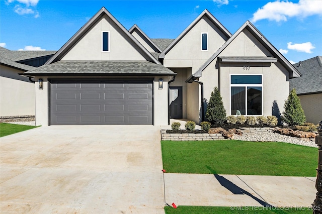 view of front of property with a front yard and a garage