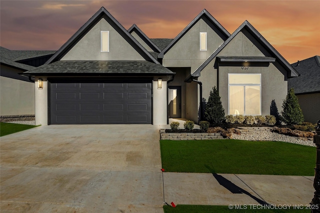 view of front of house featuring a garage and a lawn