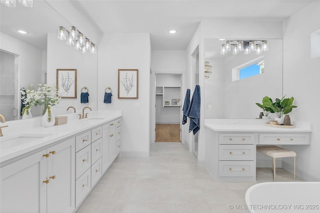 bathroom with vanity and a bath