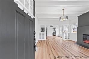 entryway featuring hardwood / wood-style floors and beam ceiling