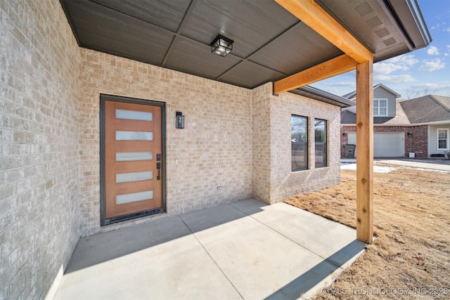 doorway to property with a patio and a garage