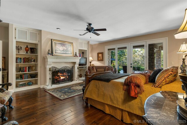 bedroom featuring ceiling fan, dark wood-type flooring, french doors, and access to outside