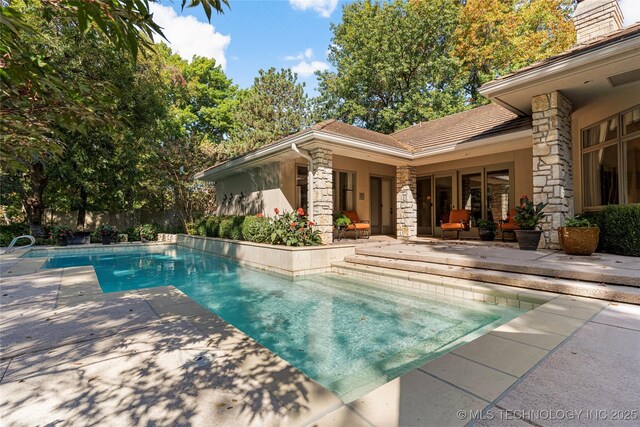 view of swimming pool featuring a patio area