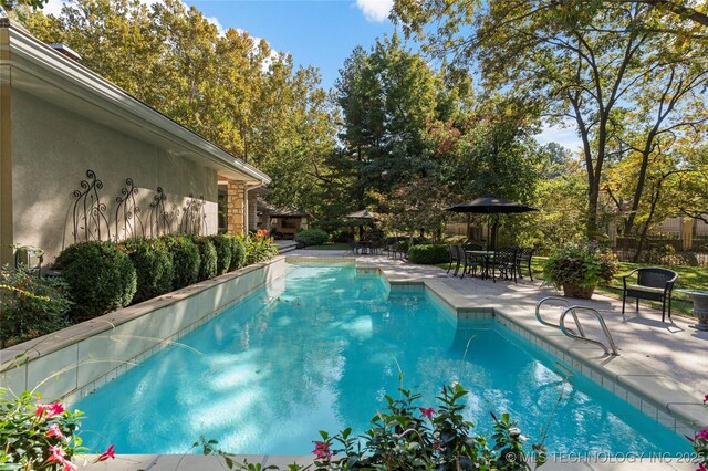 view of pool featuring a patio area