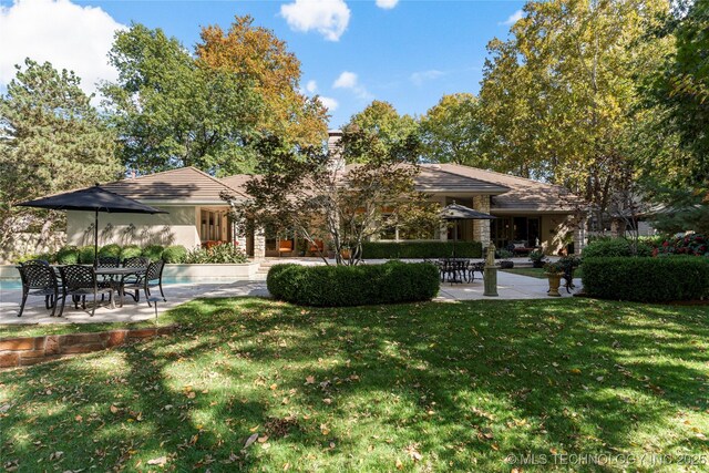 surrounding community featuring a patio area and a yard