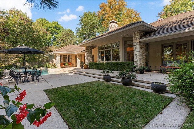 exterior space with a lawn and a patio area