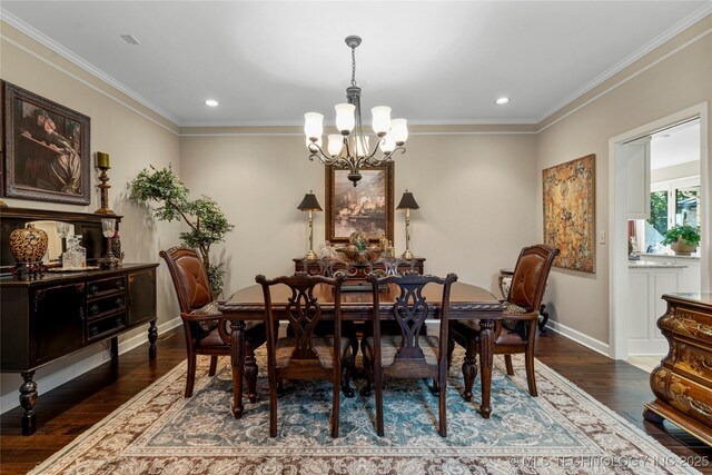 dining space with dark hardwood / wood-style flooring, crown molding, and a chandelier