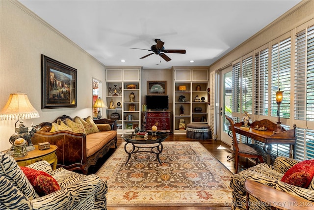 living room with ceiling fan, hardwood / wood-style floors, built in features, and crown molding