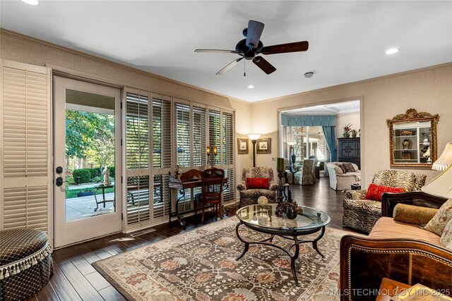 living room featuring ceiling fan, dark hardwood / wood-style flooring, and ornamental molding