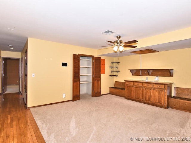 unfurnished living room featuring ceiling fan