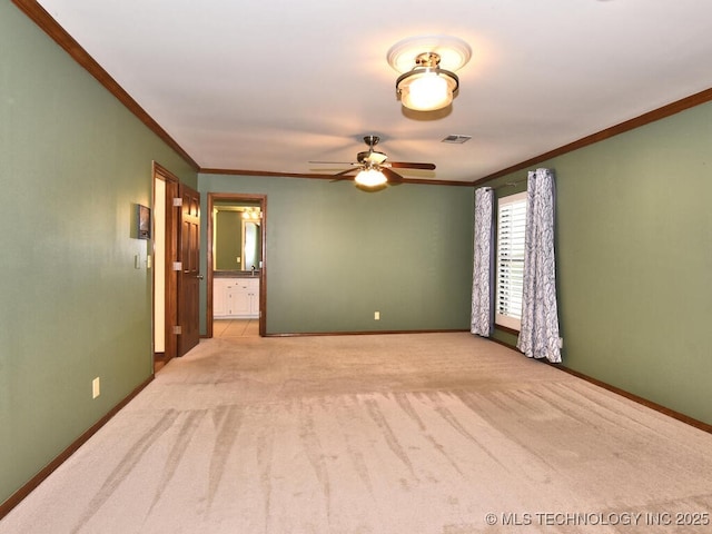 carpeted empty room with ceiling fan and ornamental molding