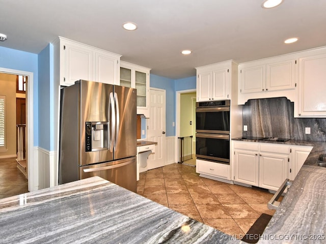 kitchen with light tile patterned floors, stainless steel appliances, and white cabinetry