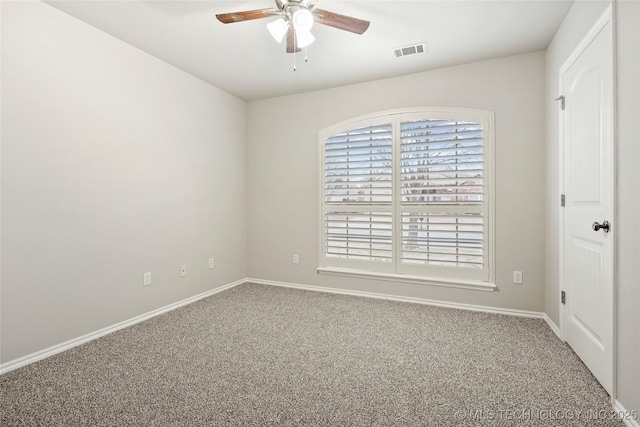 spare room with ceiling fan and carpet