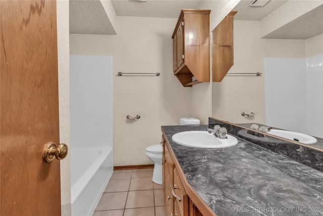 bathroom featuring a textured ceiling, tile patterned flooring, vanity, and toilet