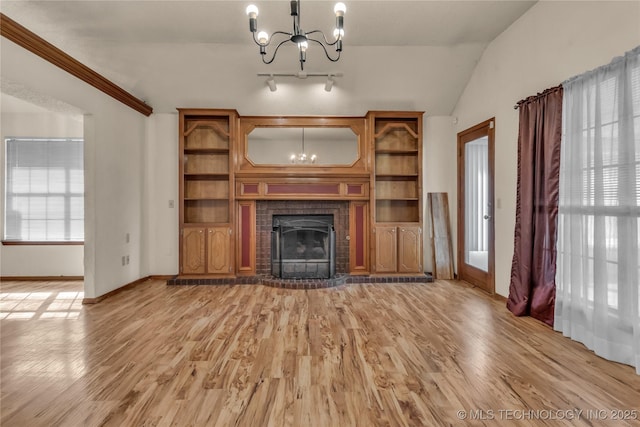 unfurnished living room with light hardwood / wood-style flooring, an inviting chandelier, and lofted ceiling