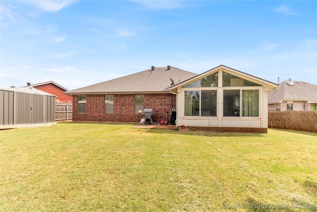 rear view of property with a yard