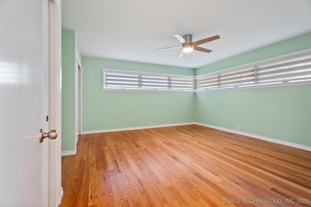 spare room with ceiling fan and light hardwood / wood-style flooring