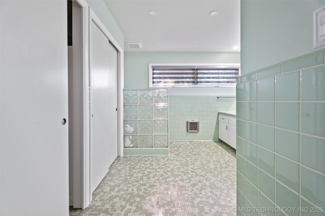 bathroom featuring tile walls and tile patterned flooring