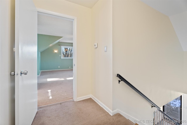 staircase with vaulted ceiling and carpet floors