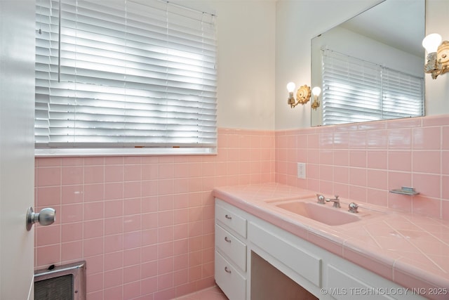 bathroom with tile walls, heating unit, and vanity