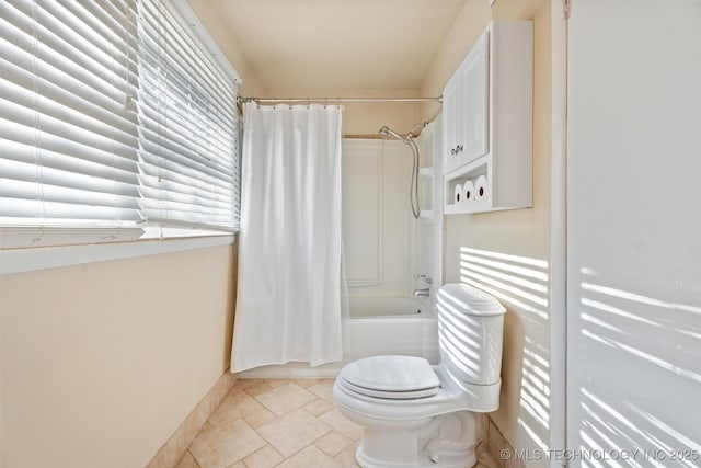 bathroom with toilet and shower / bath combination with curtain