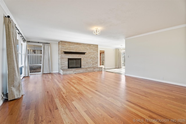 unfurnished living room with a fireplace, ornamental molding, and light hardwood / wood-style floors