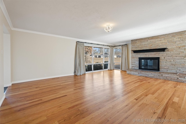 unfurnished living room featuring a fireplace, ornamental molding, and light hardwood / wood-style floors