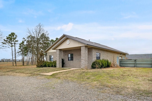 view of side of home with a yard