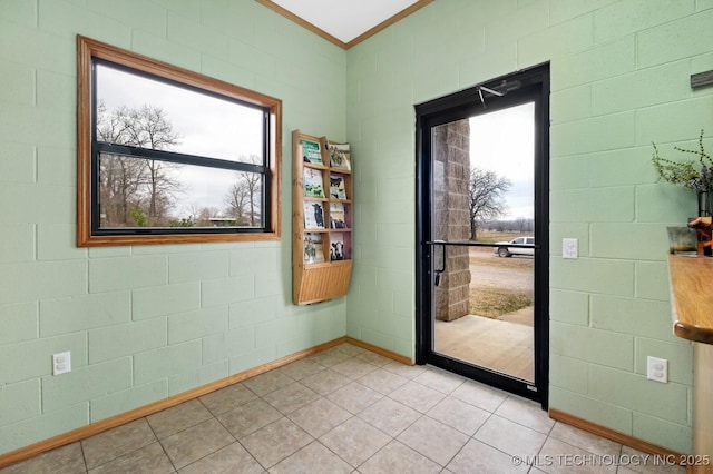 interior space with ornamental molding, brick wall, and light tile patterned floors