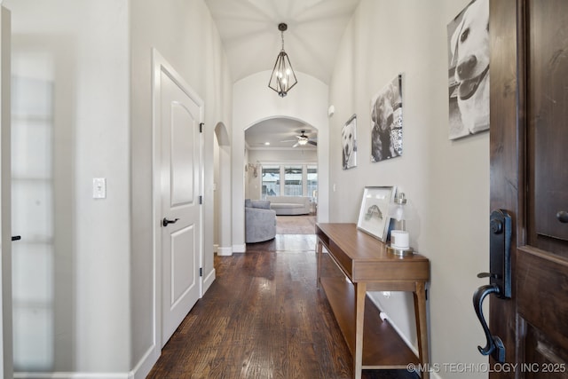 hall featuring an inviting chandelier and dark hardwood / wood-style floors