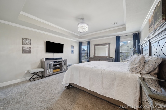 carpeted bedroom featuring a raised ceiling, crown molding, and a chandelier