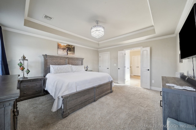 bedroom featuring ornamental molding, a notable chandelier, carpet floors, and a tray ceiling