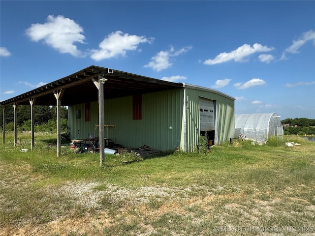 exterior space featuring a garage and a yard