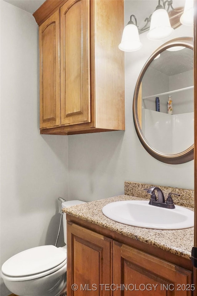 bathroom featuring toilet and vanity