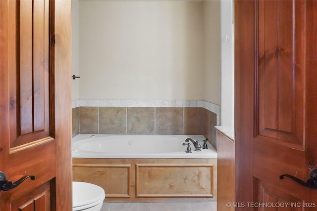 bathroom featuring toilet, a bathtub, and tile patterned flooring