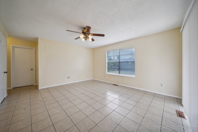 unfurnished room featuring a textured ceiling, ceiling fan, and light tile patterned floors