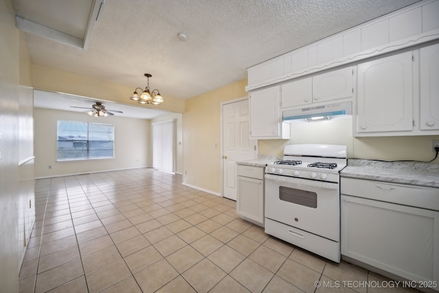 kitchen featuring white cabinets, light tile patterned flooring, white range with gas stovetop, and ceiling fan with notable chandelier