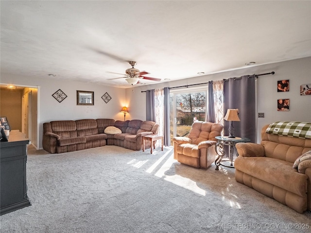 carpeted living room with ceiling fan