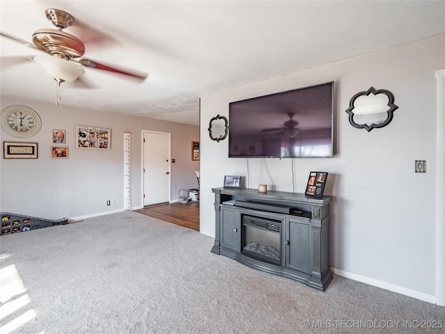 carpeted living room with ceiling fan