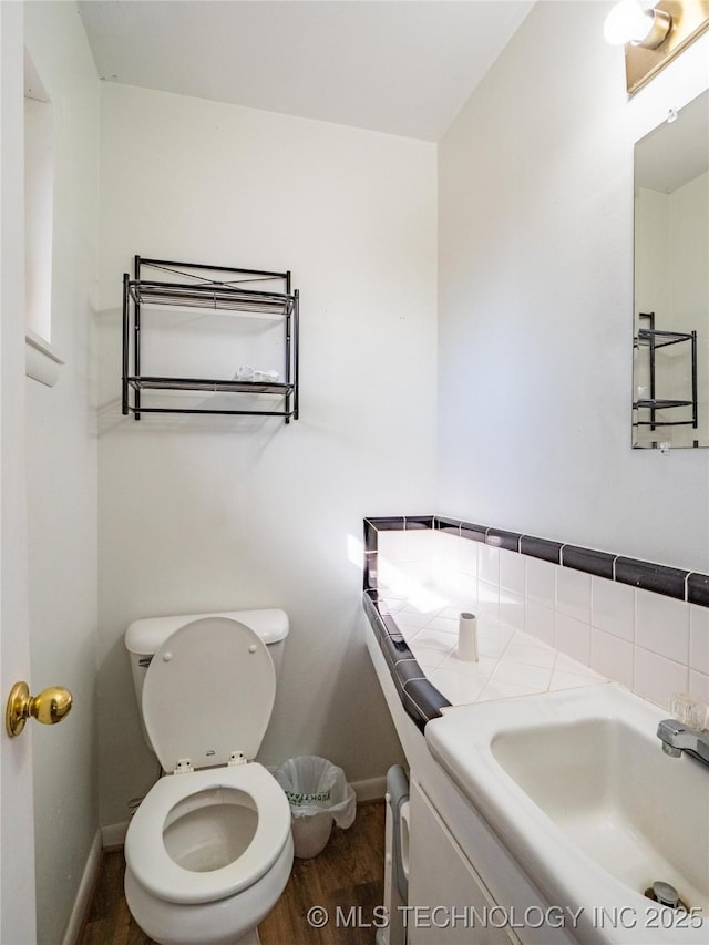 bathroom featuring sink, hardwood / wood-style flooring, and toilet