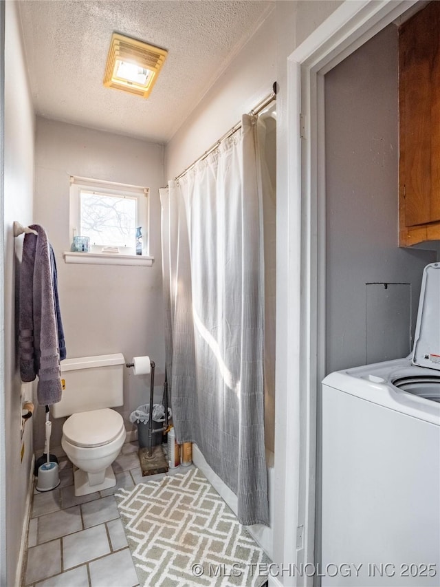 bathroom with washer / clothes dryer, a textured ceiling, tile patterned flooring, toilet, and shower / bath combo with shower curtain