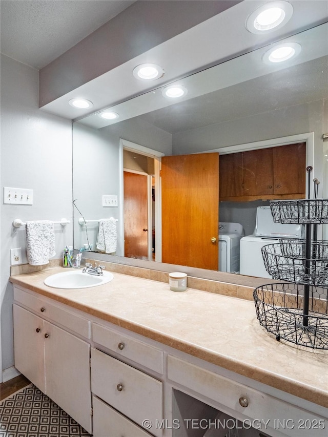 bathroom featuring washer and dryer and vanity