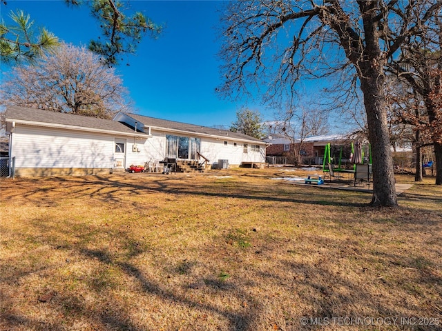 back of house with a lawn