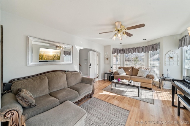 living room with ceiling fan and light hardwood / wood-style flooring