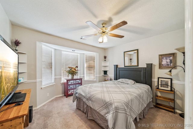 carpeted bedroom with a textured ceiling and ceiling fan