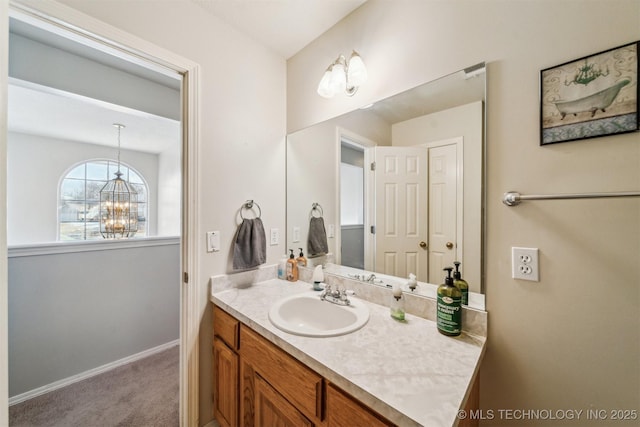 bathroom featuring a notable chandelier and vanity